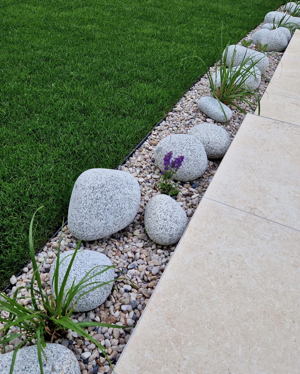 a narrow flower bed along the driveway in landscape edging ideas